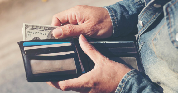 man pulling money out of wallet